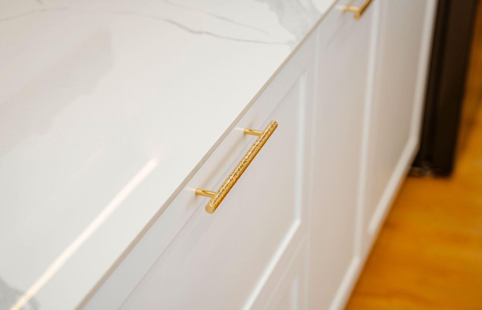 White cabinet door with a brass pull