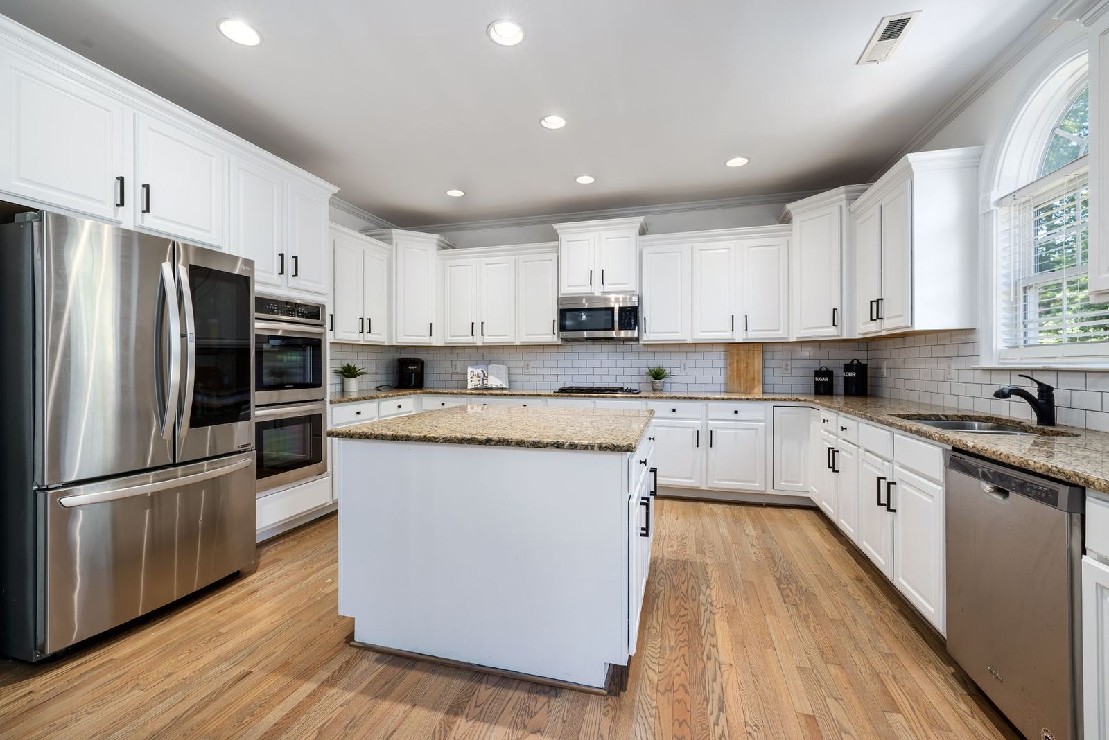 Kitchen with white cabinets and a center island