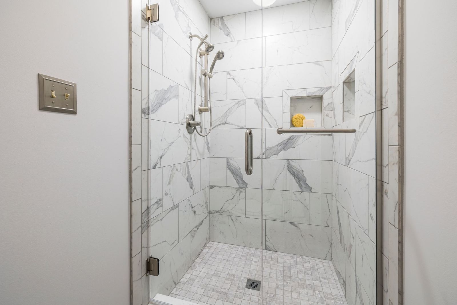 Bathroom with a marble-look tiled shower